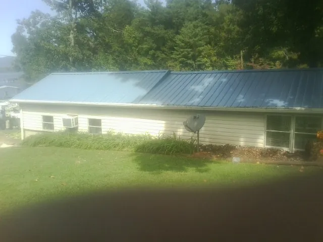 Blue metal roof running the length of a single story home in Middlefield